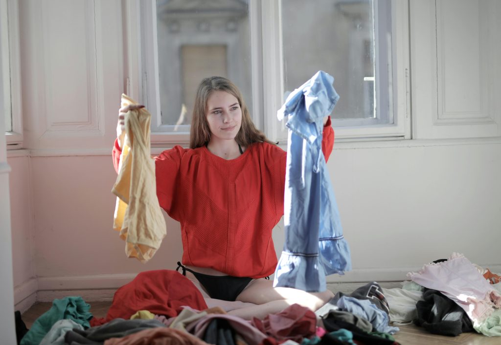 hand adjusting washing machine settings to prevent clothes from shrinking