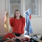 hand adjusting washing machine settings to prevent clothes from shrinking