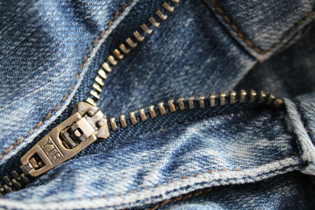 Close-up of fixing a broken zipper with pliers