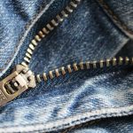 Close-up of fixing a broken zipper with pliers