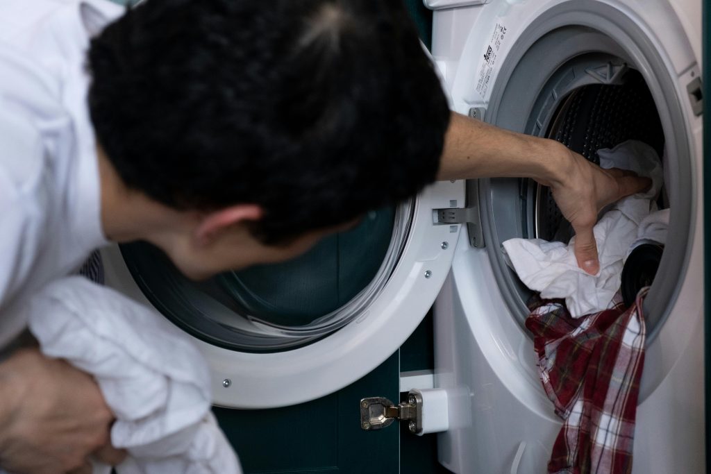 Hand cleaning a stained white shirt using home stain removal methods