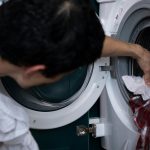 Hand cleaning a stained white shirt using home stain removal methods